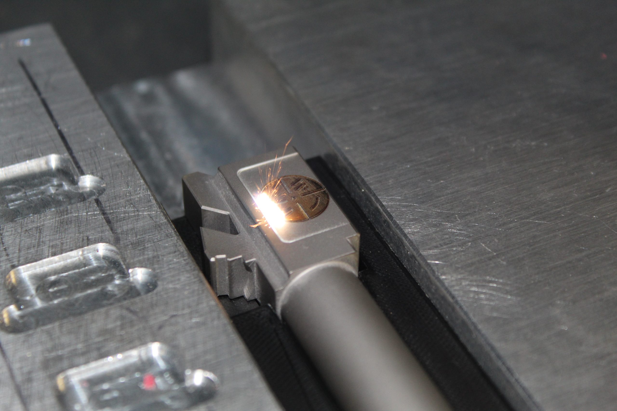 Westminster Arms logo etched into handgun part